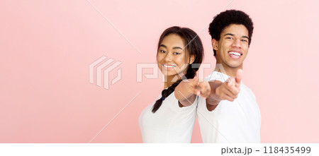 Hey, you. Overjoyed couple pointing fingers at camera over pink studio background 118435499