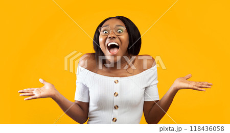 Wow. Excited Afro Girl Shouting Looking At Camera Gesturing With Hands Standing On Orange Studio Background. Panorama 118436058