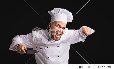 Crazy Aggressive Chef Man Holding Knives Threatening And Looking At Camera Posing Over Black Background In Studio. Panorama 118436066