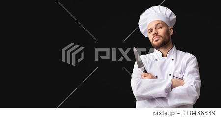 Professional Chef Posing With Knife Looking At Camera Standing Over Black Studio Background. Panorama, Empty Space Professional Chef Posing With Knife Looking At Camera Standing Over Black Studio Background. Panorama, Empty Space 118436339
