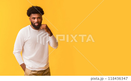 Hot african american young man posing over orange background, copy space 118436347