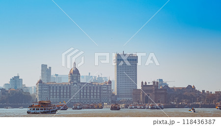 Mumbai, India. Many Boats with Tourists floating on the Arabian Sea. Tourists boats floating near Taj Mahal Palace hotel and Gateway of India. Cityscape skyline of Mumbai. Erected to commemorate the Mumbai, India. Many Boats with Tourists floating on the Arabian Sea. Tourists boats floating near Taj Mahal Palace hotel and Gateway of India. Cityscape skyline of Mumbai. Erected to commemorate the 118436387