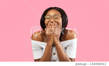 Laughter. Happy Black Girl Laughing Covering Mouth With Hands Standing On Yellow Background. Studio Shot, Panorama 118436411