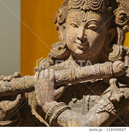 Close-up view on Statue Of Krishna Playing Flute. Krishnas Love Songs Are Both Shravya And Drishya -heard And Seen-. Krishna Is Major Deity In Hinduism. He Is God Of Protection, Compassion, And Love Close-up view on Statue Of Krishna Playing Flute. Krishnas Love Songs Are Both Shravya And Drishya -heard And Seen-. Krishna Is Major Deity In Hinduism. He Is God Of Protection, Compassion, And Love 118436687
