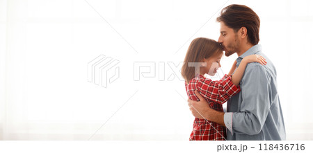 Single father kissing his preschool daughter forehead over white background, family and parenthood concept, copy space 118436716