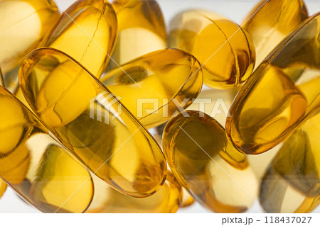 Close-up of shiny yellow vitamin capsules, healthy concept 118437027