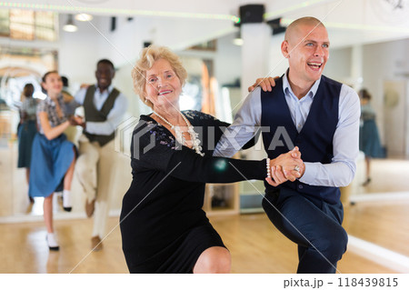 Mature woman dancing swing with young man Mature woman dancing swing with young man 118439815