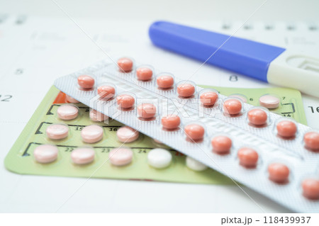 Pregnancy test and birth control pills on calendar, contraception health and medicine. 118439937