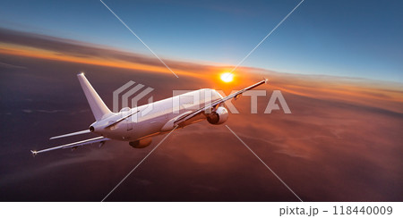 Passengers commercial airplane flying above clouds in sunset light. Concept of fast travel, holidays and business. 118440009