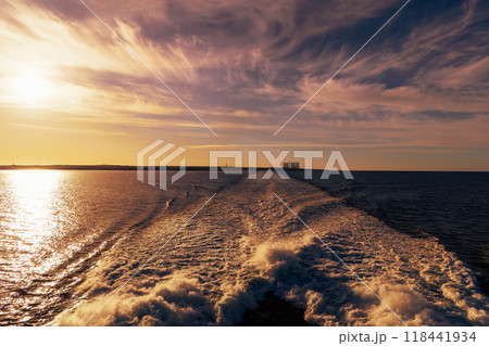 Beautiful bright sunset on the sea and waves from the ship 118441934