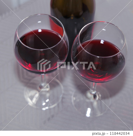 Two glasses with red wine on the table. 118442034