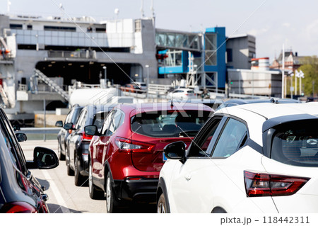 Terminal for passenger ferry transport in the city. Line of cars waiting to board the ferry. Terminal for passenger ferry transport in the city. Line of cars waiting to board the ferry. 118442311