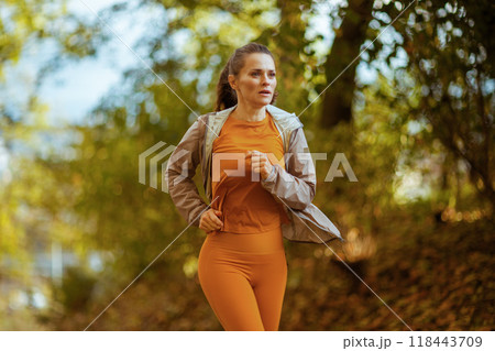 modern woman in fitness clothes in park running modern woman in fitness clothes in park running 118443709