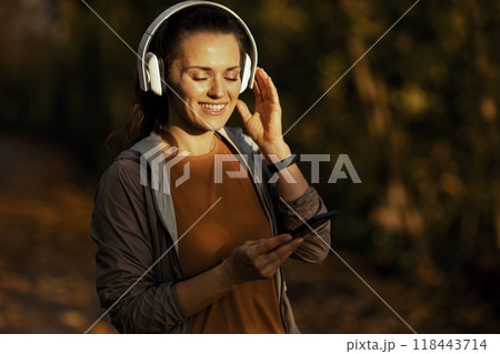happy young woman in fitness clothes in park happy young woman in fitness clothes in park 118443714