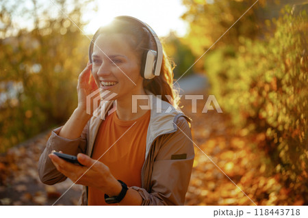 smiling trendy woman in fitness clothes in park smiling trendy woman in fitness clothes in park 118443718