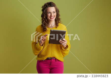 happy trendy woman isolated on green background 118443823