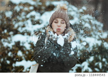 40 years old woman outdoors in park in winter blowing snow 118444543