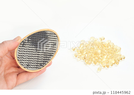 Hand holding microscopic view of microplastics with capsules on white background Hand holding microscopic view of microplastics with capsules on white background 118445962