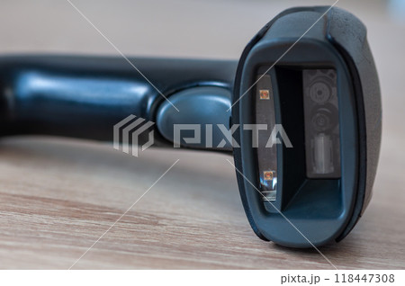 Handheld scanner on a wooden table 118447308