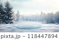 A podium set in a snowy forest with evergreen trees and soft snow covering the ground, ideal for winter or holiday-related presentations 118447894