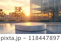 A white concrete podium on a modern rooftop with city skyscrapers in the background at sunset. Ideal for urban or contemporary product presentations 118447897
