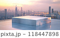 A reflective podium on a rooftop terrace with a city skyline and soft evening light, ideal for high-end or luxury product presentations 118447898