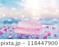 A pink crystal podium surrounded by sparkling lights and scattered petals, suitable for wellness or beauty-related product displays 118447900