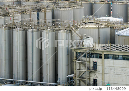 Many tall metal tanks in tank farm, high silos, multiple steel tanks to storage chemical products 118448099