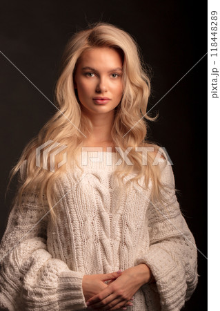 Studio photo portrait of a young pretty blonde on a dark background, close-up portrait of a woman 118448289