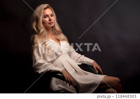 Studio photo portrait of a young pretty blonde on a dark background, close-up portrait of a woman 118448303
