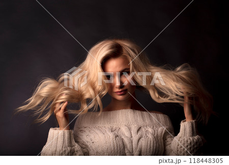 Studio photo portrait of a young pretty blonde on a dark background, close-up portrait of a woman Studio photo portrait of a young pretty blonde on a dark background, close-up portrait of a woman 118448305