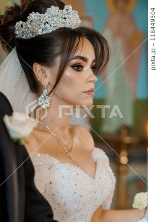 Elegant Bride in Sparkling Gown and Ornate Tiara on Her Wedding Day 118449304