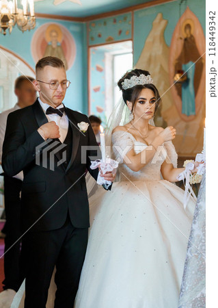 Elegant Wedding Ceremony in Ornate Church Setting Capturing Sacred Traditions and Timeless Love 118449342