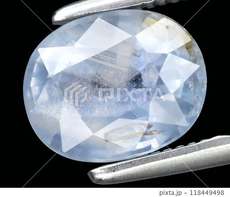 Stunning Faceted Blue Sapphire Gemstone Held by Metal Tweezers Highlighting Its Translucent Beauty Stunning Faceted Blue Sapphire Gemstone Held by Metal Tweezers Highlighting Its Translucent Beauty 118449498