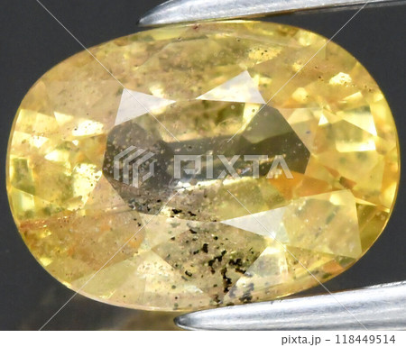 Radiant Yellow Sapphire Gemstone with Intricate Facets and Unique Inclusions Captured in Detailed Close-Up Radiant Yellow Sapphire Gemstone with Intricate Facets and Unique Inclusions Captured in Detailed Close-Up 118449514