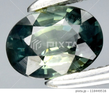 Captivating Teal Green Sapphire Gemstone in Precision Cut Displayed with Tweezers for Jewelry and Gemology Design 118449516