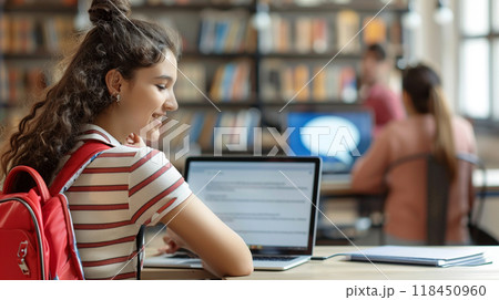 Student Studying in Library with Laptop 118450960