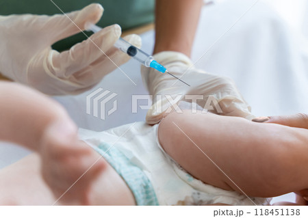 Nurse vaccinates newborn at hospital providing protection against diseases 118451138