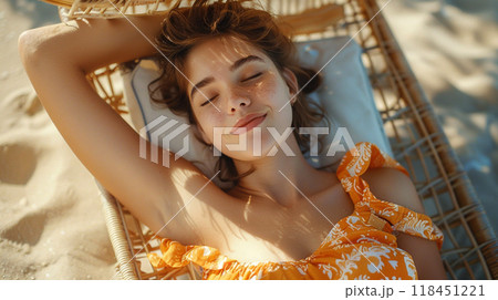 Woman Relaxing on a Beach Hammock 118451221