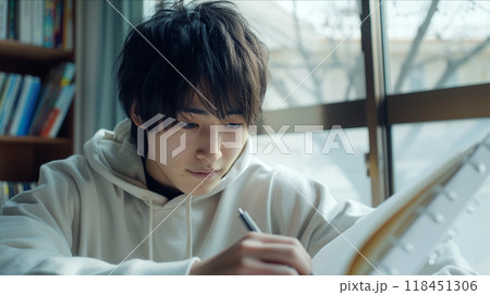 Focused Student Studying with Notebook 118451306