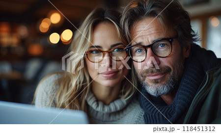 Couple with Laptop in Cozy Cafe Couple with Laptop in Cozy Cafe 118451312