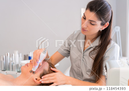 Woman receiving facial ultrasonic skincare Woman receiving facial ultrasonic skincare 118454393