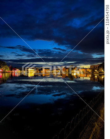 The skyline of Sweden. A night shot with picturesque water reflections, featuring houses by the Melaren River. Eskilstuna. 118454708