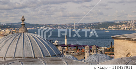 Explore a stunning panoramic vista of the Bosphorus strait framed by traditional domes and scenic hills in vibrant Istanbul. Explore a stunning panoramic vista of the Bosphorus strait framed by traditional domes and scenic hills in vibrant Istanbul. 118457911