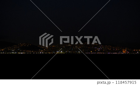 The vibrant lights of Istanbul twinkle against the dark sky, reflecting on the water as the city comes alive after sunset. 118457915