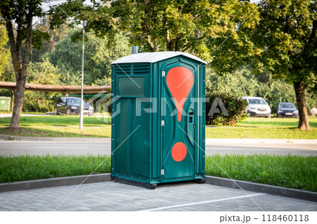 Green mobile toilet in the car parking outdoors, a temporary solution Green mobile toilet in the car parking outdoors, a temporary solution 118460118
