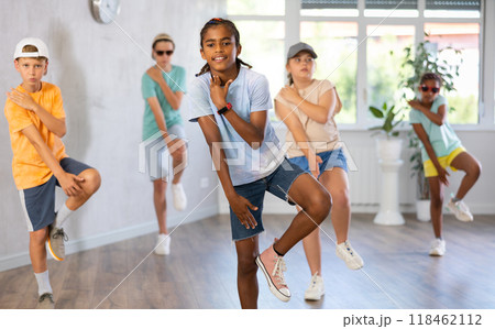 Dark-skinned preteen boy krumper dancing in choreographic studio Dark-skinned preteen boy krumper dancing in choreographic studio 118462112
