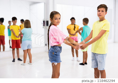 Kids in pairs standing in dance studio Kids in pairs standing in dance studio 118462294
