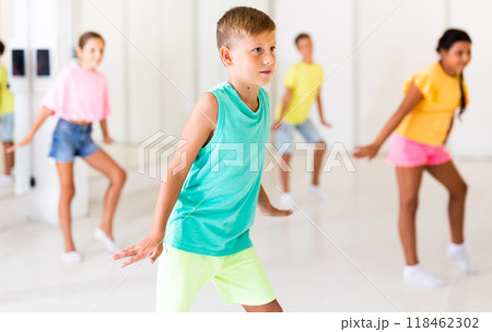 Group children learn dance movements in class 118462302