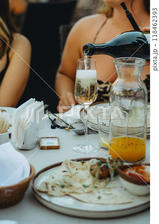 Hand pouring wine to the glasses close-up The waiter pours pink sparkling wine 118462393